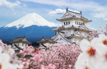 picture of snowy mountain with a Japanese style building in the front