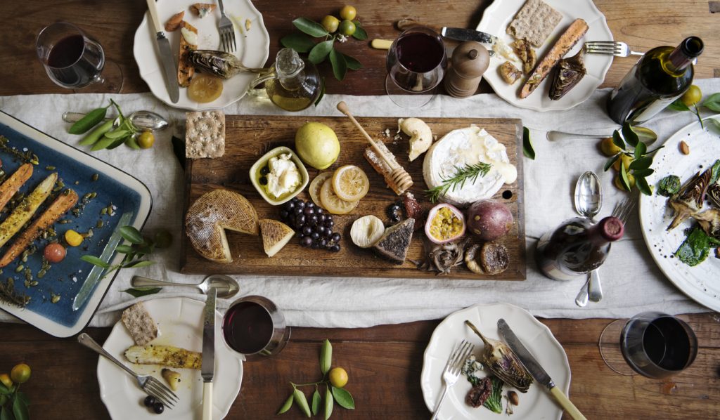 a top down shot of the French cuisine layer on the table. It showcases multiple food items that are French.