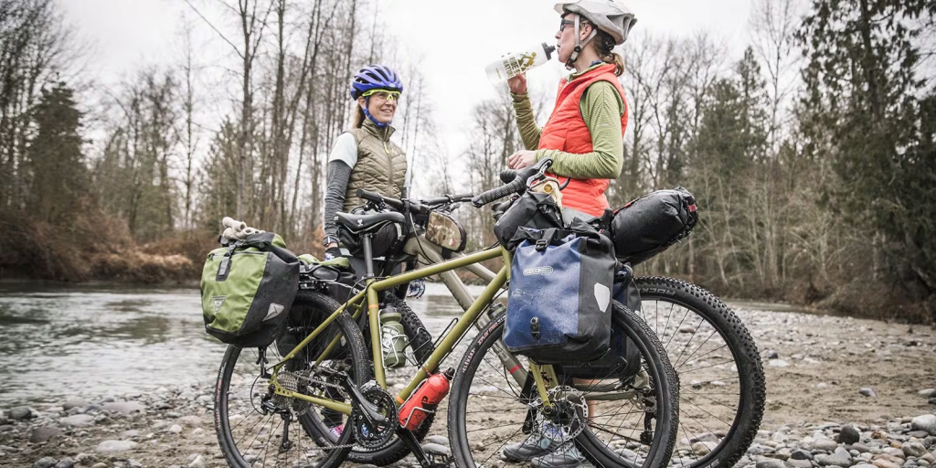 2 girls on cycle road trip drinking water